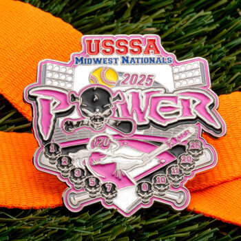 USSSA Midwest Nationals 2025 Power softball medal with pink accents, skull imagery, and an orange ribbon on green turf.