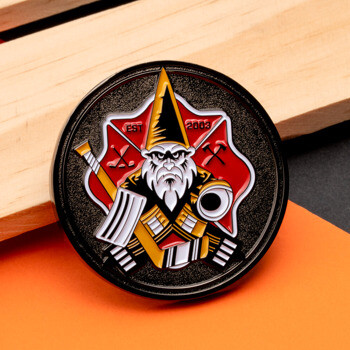Circular challenge coin featuring a bearded gnome warrior in front of a red shield with Est 2003 text.
