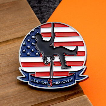 Enamel lapel pin featuring a silhouette of a person rappelling against a circular American flag background with a ribbon reading Station 3 Midtown.