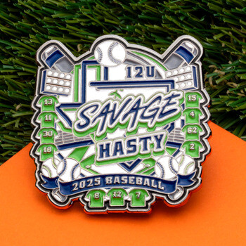 Custom 2025 Savage Hasty 12U baseball trading pin featuring crossed bats, baseballs, and lime green jerseys on an artificial turf and orange background.