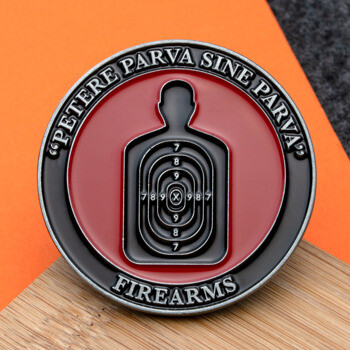 Round challenge coin featuring a black shooting range target silhouette on a red background with the word Firearms.