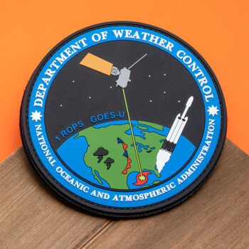 Circular PVC patch for Department of Weather Control featuring a satellite, rocket, and Earth with 1 ROPS GOES-U text.