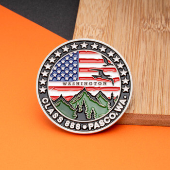 Round challenge coin featuring the American flag, mountains, evergreen trees, and the text Class 888 Pasco, WA.