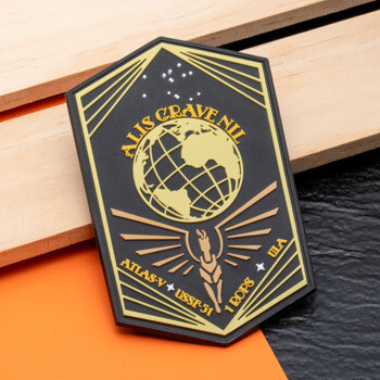 Shield-shaped PVC patch featuring a globe, torch, and text 'Alis Grave Nil' and 'USSF-51' in gold and black.