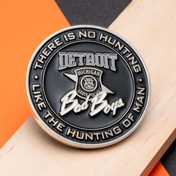 Circular black enamel challenge coin featuring Detroit Michigan State Police shield emblem and Bad Boys script.