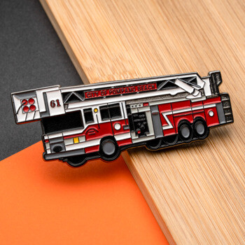 Red and white fire truck lapel pin featuring City of Pompano Beach text and number 61.