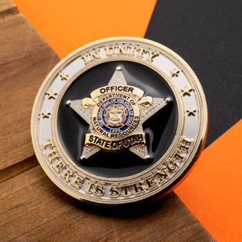 Gold and black challenge coin featuring a five-pointed officer star for the Utah Department of Natural Resources.