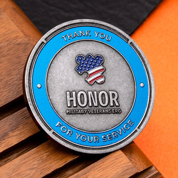 HONOR Military Veterans ERG challenge coin featuring a blue border and American flag puzzle piece on antique nickel finish.