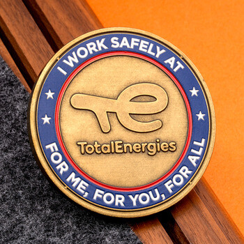 TotalEnergies I Work Safely bronze challenge coin with blue and red enamel border