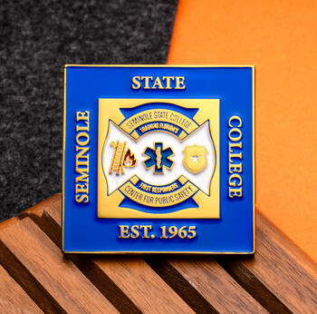 Square blue and gold challenge coin for Seminole State College Center for Public Safety featuring a firefighter cross emblem.