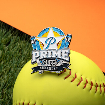 Softball trading pin featuring a blue glitter star, crossed bats, and the text Prime 2025 Arkansas on a yellow softball.